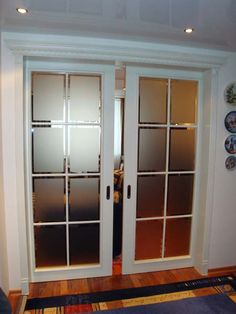 two doors with frosted glass are open in the living room, while another door is closed