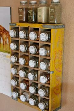 a wall mounted spice rack filled with lots of spices