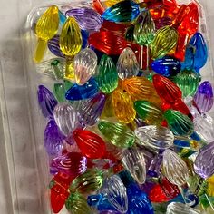 many different colored glass beads in a plastic container