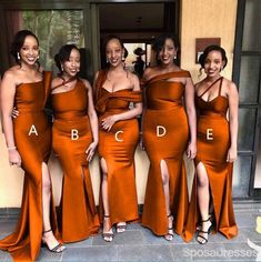 the bridesmaids are posing in their orange dresses