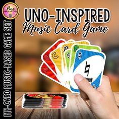 the uno - inspired music card game is being held up in front of a wooden table