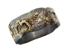 a close up of a ring with gold and black metal in it's center