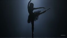 a ballerina is dancing in the dark