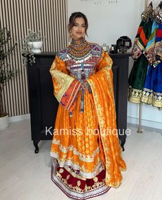 a woman wearing an orange and gold dress