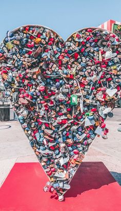 a large heart shaped sculpture made out of skateboards and padlocks in the shape of a heart