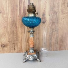 a blue glass lamp sitting on top of a table