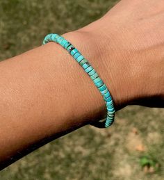 A simple and earthy bracelet beaded with genuine Kingman turquoise from the state of Arizona. These stones are cut in a flat round heishi shape, and the beads measure approximately 3-4mm in size. The color is a teal blue/aqua color, with some natural vein markings of brown and gray in some areas. Made to order in the length of your choice, and connects with a sterling silver lobster claw clasp. This item ships in 1 business day. Interested in a matching necklace? You can find that here: https:// Minimalist Turquoise Hand-strung Bracelets, Adjustable Turquoise Hand-strung Beaded Bracelets, Affordable Turquoise Beaded Bracelets, Casual Style, Southwestern Hand-strung Blue Bracelet, Bohemian Turquoise Hand-strung Beads, State Of Arizona, Kingman Turquoise, Aqua Color, Bracelet Beaded