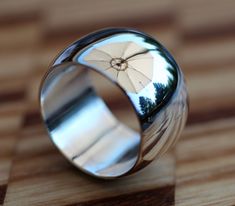 "Custom made to your desired ring size. You choose between a 5/16ths\" or 1/2\" wide width. The 16 gauge (1.30mm) thick .935 purity Argentium Silver band is hand forged in a steel dapping block creating an extra thick, domed exterior. Rich looking with a substantial weight and comfortable feel." Sterling Silver Wedding Band, Silver Wedding Bands, Argentium Silver, Silver Wedding, Hand Forged, Silver Band, Wedding Band, Wedding Bands, Custom Made