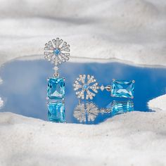 Every winter, we look forward to the first sight of a snowflake. Enjoy the beauty year-round with these bewitching sterling silver snowflake earrings. Polished metal and glittering stones come together to create this unique jewelry, for a sophisticated yet sparkling look. Wear these drop earrings while gathering by the fireplace in winter holidays, or simply to feel cooler on a hot summer day, or just to add a touch of wintry magic to your everyday look. Polished to a brilliant shine, these piec Sparkling Snowflake Sterling Silver Jewelry, Snowflake Shaped Sparkling Sterling Silver Jewelry, Sparkling Snowflake Jewelry In Sterling Silver, Elegant Sterling Silver Snowflake Jewelry, Silver Snowflake Jewelry For Formal Occasions, Elegant Snowflake Earrings For Parties, Formal Silver Snowflake Jewelry, Formal Snowflake Sterling Silver Jewelry, Sterling Silver Snowflake Earrings