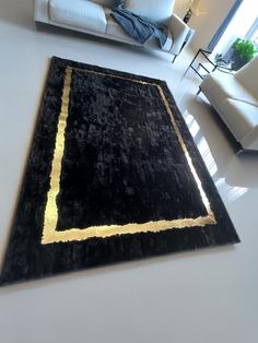 a black and gold area rug in a living room