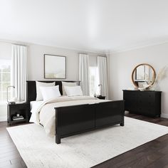 a white and black bedroom with wood flooring, large windows, and a rug on the floor