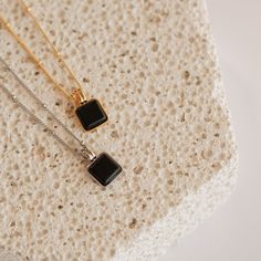 Statement meets simplicity with our beaded Waverly Charm Necklace featuring a dainty black enamel square pendant on a satellite chain and adjustable lobster claw clasp closure. Pair with jeans or your favorite skirt and you have a go-to outfit piece. Material: High Quality Solid 925 Sterling Silver Finish: Sterling Silver ∙ 18K Gold Featuring an ~8mm Black Enamel Square Pendant, with a satellite chain - adjustable length 16 inches to 18 inches SKU: RR-NR106 Chic Everyday Necklace With Rectangular Pendant, Chic Everyday Rectangular Necklaces, Chic Everyday Rectangular Necklace, Trendy Black Sterling Silver Necklace, Black Pendant Charm Necklace, Black Pendant Charm Necklace For Everyday, Everyday Black Sterling Silver Charm Necklace, Everyday Black Pendant Charm Necklace, Black Necklace With Rectangular Pendant For Everyday