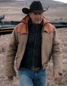 a man in a cowboy hat is walking through the desert with a helicopter behind him