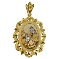 14 Karat Yellow Gold Butterflies and Roses Hand Painted on a Mother of Pearl Pendant. The miniature painting is set in a 14 karat gold ornate oval frame with diamond-cut details. The painting is signed by the master artist, BKM Brian M. The pendant measures 40mm high (including bail) x 23.7mm wide. Marked with a sticker on the back on each pendant is "An Authentic Hand Painting 1977 Polynesian Artifacts". Stamped on the back of the bail is 14K. The pendant comes with a certificate of authenticit Art Pendant, Oval Frame, Gold Butterfly, Hand Painting, Delicate Details, Miniature Painting, Pearl Pendant, Diamond Cut, Jewelry Necklace Pendant