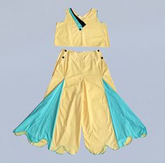 "Incredible bright yellow and blue 1930s beach pajama set with exaggeratedly flared bell bottoms. The trousers are flat front with slightly elasticized waist. Front button closures in the naval style. The belled legs feature contrasting godets, which fan open or gently pleat closed as they are worn. Scalloped hems with matching blue piping. The coordinating tank top features a wide boxy cut, v neck, and sporty appliqueed color block neckline. Sleeveless with blue piping at armholes. Such a wonderful example of early 30s sportswear. LAYAWAY is available for all items, please message me for details. Measurements:  TOP Bust: 43\" Waist: 46\" Length: 11.5 BOTTOMS: Waist: 32\" Hip: 45\" Length: 37\" Inseam: 21\"  Rise: 17\" Condition: Excellent. A few small spots but nothing detracting. @guerma Yellow Wide Leg Summer Sets, Yellow Wide Leg Sets For Summer, Embroidery Jumpsuit, Beach Pajamas, Womens Pj Sets, Cotton Loungewear, Collar Jumpsuit, Silk Pajama Set, Cotton Jumpsuit