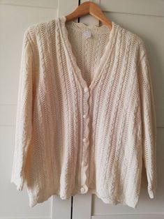 Gorgeous butter white cable knit cardigan, assorted buttons in front, v neck and padded shoulders.  Distance between shoulders 49 cm Length  65/67 cm Sleeve length  57 cm Bust  110 cm Waist 108 Size on label XL. Made in Portugal.  Good condition, very delicate. White V-neck Cable Knit Cardigan, Cream V-neck Cable Knit Cardigan, Classic White Textured Knit Cardigan, Classic Knitted Cream Cardigan, Classic Cream Knitted Cardigan, Classic Cream Cable Knit Cardigan, Vintage Cream V-neck Cardigan, White Vintage Knitted Cardigan, Vintage Cream Cable Knit Cardigan