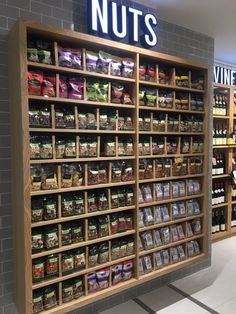 a store display filled with lots of nuts and other foods in bins on the wall