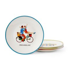 three plates with an image of two people on bicycles