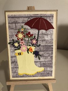 an easel with flowers and a red umbrella