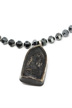 The Mya Lambrecht Buddha Necklace is minimal yet striking! Material: Natural stones, metalOrigin: Made in Minnesota Hook closure Handmade sitting Buddha from Thailand Ancient Chinese I-Ching coin Hematite 28" long Mya Lambrecht incorporates everyday objects into her pieces that are seemingly out of place. Her pieces create a relationship between people and the earth. Oxidized Pendant For Meditation, Symbolic Oxidized Finish Necklace For Meditation, Handmade Brass Spiritual Coin Necklace, Oxidized Finish Pendant For Meditation, Spiritual Oxidized Finish Jewelry For Meditation, Adjustable Amulet Necklace With Oxidized Finish, Meditation Amulet Style Long Necklace, Amulet Style Long Necklace For Meditation, Meditation Amulet Long Necklace