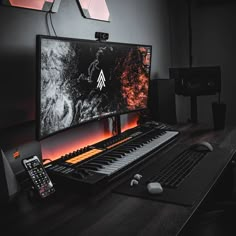 a computer monitor sitting on top of a wooden desk next to a keyboard and mouse