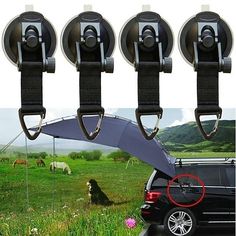 there are four car hooks attached to the side of a vehicle with cows in the background