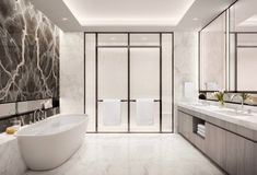 a large bathroom with marble walls and flooring, along with a freestanding bathtub