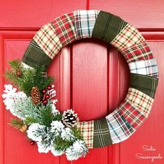 a christmas wreath hanging on a red door