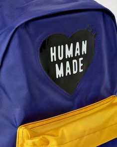 The Human Made Backpack delivers a sleek, lightweight design with a standout PVC heart logo and practical functionality. Featuring a spacious main zip compartment, an inner pocket, and adjustable padded shoulder straps, this bag combines street-ready style with everyday utility. PVC heart logo on the front. Patch label on the back. Interior woven patch label. Main zip compartment with inner pocket. Front compartment with a branded webbing loop under. Adjustable padded shoulder straps. 100% Nylon Everyday Backpack With Logo, Modern Backpack With Logo Patch, Everyday Logo Backpack, Nylon Backpack With Logo For Everyday Use, Everyday Nylon Backpack With Logo, Everyday Nylon Bag With Logo, Functional Everyday Backpack With Logo Patch, Modern School Backpack With Logo, School Nylon Bag With Logo