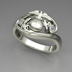 a silver ring with an eagle and globe on the front, surrounded by crystal stones