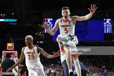 two men are jumping in the air during a basketball game