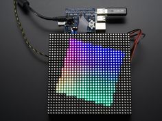 an image of a colorful display on a black surface with wires attached to the board