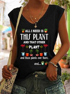 a woman wearing a black shirt with plants on it and the words, all i need is this plant and that other plant and those plants over there