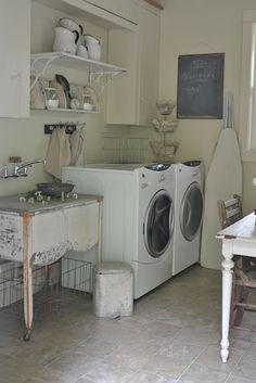 a white washer sitting inside of a kitchen next to a window