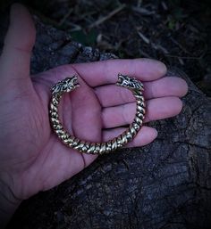 This is one special piece of metal, a Norse viking arm ring with wolf heads, a perfect present for any modern pagan warrior. Purchase it to surprise your man for the holidays, or get one of these for yourself, you know you deserve it. The bracelet is made out of bronze, hence the golden color. It is cast as a single piece of metal, so it is very sturdy and durable, created out of a special alloy that is resistant to any corrosion and color change. The size can be slightly corrected to better acc Viking Style Handmade Gold Jewelry, Handmade Viking Gold Jewelry, Handmade Viking Style Gold Jewelry, Viking Style Bronze Jewelry Gift, Medieval Gold Bracelet Jewelry, Medieval Style Gold Bracelet, Viking Style Metal Bracelet Jewelry, Viking Style Metal Bracelet For Gift, Bronze Viking Jewelry Collectible