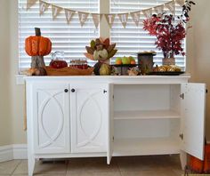 a buffet table is decorated with fall decorations