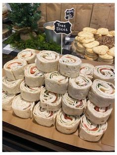 a table topped with lots of sandwiches and cookies