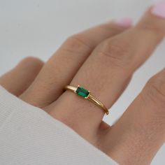 Beautifully crafted emerald ring is a true stunner! Looks great stacked or on its own! - - - D E T A I L S - - -  * Made of 925 Sterling Silver * We use a THICK plating of 14k Gold or Rhodium * Available in sizes 4-10 * 3x5mm Baguette Stone * Nickel-free & Hypoallergenic - Will not turn your fingers green! * Made of the highest grade cubic zirconia for an authentic look! * Also available in White Cubic Zirconia  https://www.etsy.com/listing/1327774787/baguette-ring-dainty-stacking-ring?click_key=1cbb852cd51339c29f8a763fa5c7a3085b2fd29f%3A1327774787&click_sum=b630e565&ga_search_query=baguette%2Bring&ref=shop_items_search_19&pro=1&sts=1 If you're unsure of your ring size, we recommend trying our ring size tool! https://www.etsy.com/listing/1240904225/ring-sizer-reusable-ring-sizer-plastic?cl Gold Emerald Ring Engagement, Dainty Emerald Rings, Elegant Green Emerald Cut Stackable Rings, Green Emerald Cut Stackable Rings For May Birthstone, Green Emerald Cut Stackable Emerald Ring, Classic Green Emerald Cut Stackable Rings, Classic Green Emerald-cut Stackable Rings, Green Emerald Open Ring Stackable Rings, Green Emerald Solitaire Stackable Rings