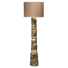 a lamp made out of wood stacked on top of each other with a beige shade