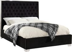 a bed with white sheets and black headboard on it's side, in front of a white background