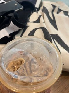 an iced beverage in a plastic cup on a wooden table