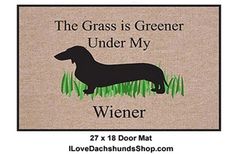 a door mat with a dachshund on it that says, the grass is greener under my wiener