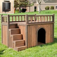 a dog house made out of wood with stairs leading up to the top and bottom