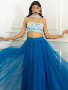 A three-piece Azure Blue multi sequins lehenga set from the Shrena Hirawat collection. This beautiful blue multi sequins strapless blouse is paired with a net blue tulle skirt lehenga. The multi sequin floral embroidery with net and butter crepe lining enhance this lehenga set. This outfit is completed with an ombre dupatta with lace border detail. Ombre Dupatta, Skirt Lehenga, Sequins Lehenga, Strapless Blouse, Blue Tulle Skirt, Blue Tulle, Azure Blue, Lace Border, Three Piece