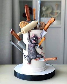 a cake decorated to look like an animal holding knives