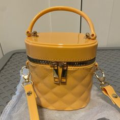 This Is An Unbranded Cute Little Bag In Light Orange-Yellow Color. Very Cute, With Zipper Closure. Can Still Hold Quite A Bit, But Not A Phone. Approx Size: 4.75” X 4” Strap Approx: 45.5 (End To End) Not Adjustable. Thanks For Looking! Yellow Crossbody Bucket Bag For Travel, Yellow Bucket Bag For Travel, Trendy Yellow Bucket Bag With Detachable Strap, Casual Yellow Bags With Zipper Closure, Trendy Mustard Shopping Bag, Trendy Yellow Pouch Bucket Bag, Trendy Portable Yellow Bags, Trendy Yellow Bucket Bag, Trendy Mustard Shoulder Bag