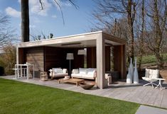 an outdoor living area with furniture and trees