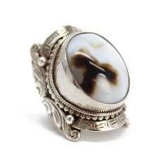 "Wozer! This is a RING! A beautiful brown and white banded agate hand bezel set in a huge, ornate sterling silver setting! This ring definitely makes a statement. Size 10 US - can not be resized Stamped 925 inside band Face of the ring is 1.47\" L (37.4mm) x .94\" W (24mm) Band tapers to 6mm at the back 30.6 g - substantial weight Vintage I found this ring in an estate sale. It is a used item. It does show some signs of wear consistent with its age. Please inspect photos closely. It is working a White Agate Cabochon Jewelry, Bohemian White Collectible Rings, White Oval Carved Rings, White Oval Carved Ring, Oval Carved White Ring, Antique White Oval Cabochon Jewelry, White Agate Rings Suitable For Gifts, Elegant Agate Rings For Collectors, White Agate Rings As A Gift