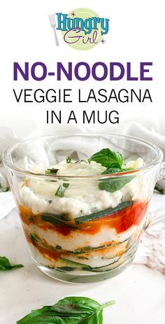 no - noodle veggie lasagna in a mug with spinach leaves on the side