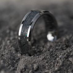 a wedding band that has been made to look like it is in the middle of some dirt